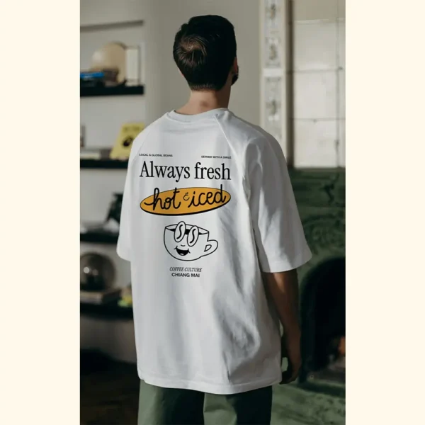 Lifestyle photo of Amici al Sole’s “Coffee Culture” t-shirt, worn in a cozy café workspace.